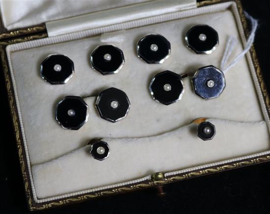A cased eight piece 9ct gold, platinum, onyx and seed pearl gentlemans dress studs and cufflinks set.